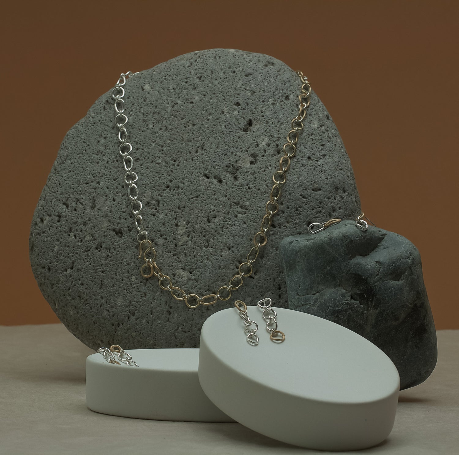 Gold and silver handcrafted organic shaped chain necklaces and earrings. Made in 14K and sterling silver .